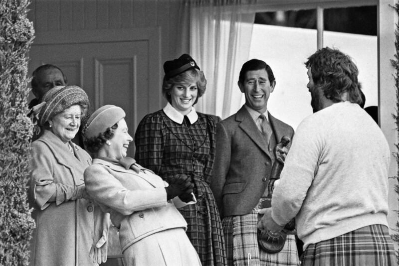 The queen, Princess Diana, and Prince Charles share a joke as they attend the Braemar Highland Games in 1982.