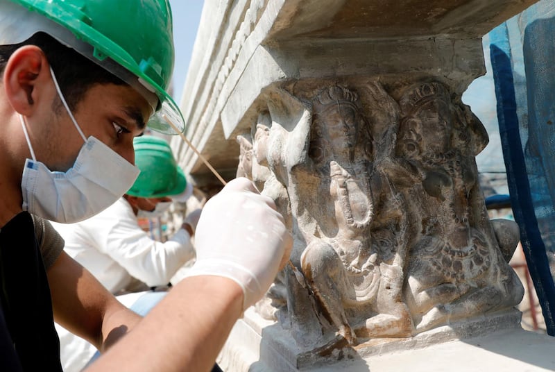 An Egyptian archaeologist works on restoring relief sculptures at the palace, which was built in the 20th century by Belgian industrialist Edouard Empain. Reuters