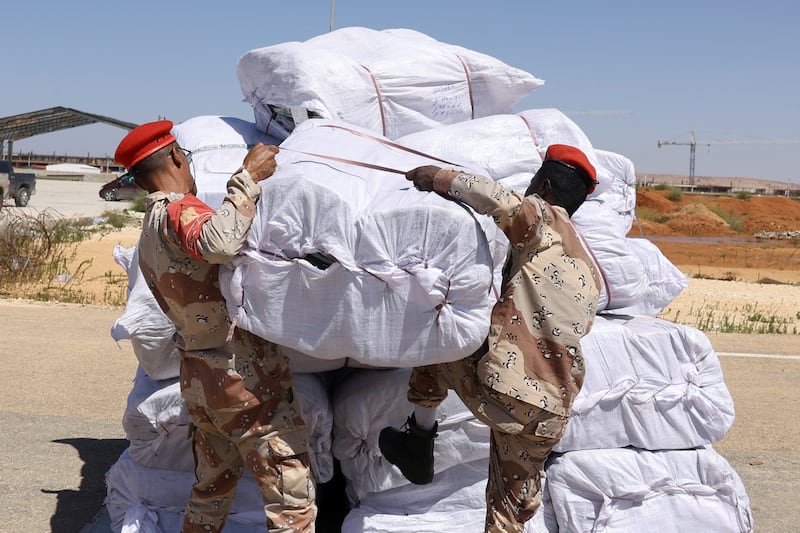 Libyan military officers handle relief items arriving from the UAE. Reuters