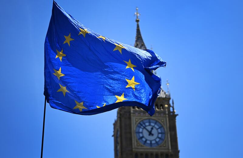 An EU flag flies outside Parliament in London where legislators plan to scrap parts of the post-Brexit trade deal between the UK and Europe. EPA.