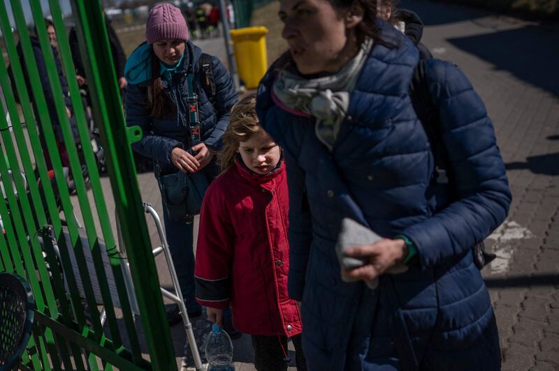 Ukrainian refugees cross the border at the Medyka crossing into south-eastern Poland. AFP