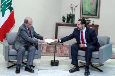 epa07958211 A handout photo made available by Lebanon's official photographer Dalati Nohra shows Lebanese President Michel Aoun (L) receiving letter of resignation from Prime Minister Saad Hariri, at the presidential palace, in Baabda, east of Beirut, Lebanon 29 October 2019. Hariri on 29 October said he will submit his resignation to the president following about two weeks of anti-government protests that started against proposed taxes and later continued against corruption and economic situation.  EPA/DALATI NOHRA HANDOUT  HANDOUT EDITORIAL USE ONLY/NO SALES