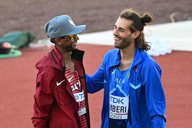 Mutaz Barshim speaks to Gianmarco Tamberi after the men's high jump final at the World Athletics Championships. AFP