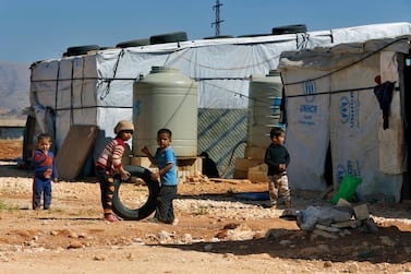 In this June 2017 file photo, Syrian refugee children play outside their family tents at a refugee camp in the eastern Lebanese city of Baalbek. AP