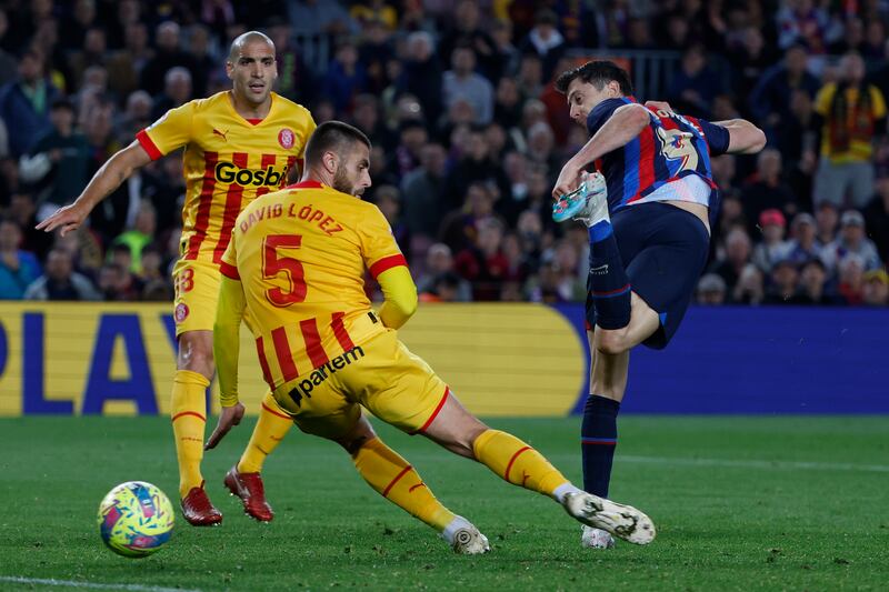 Barcelona's Robert Lewandowski, right, attempts a shot at goal and misses in front of Girona's David Lopez. AP Photo