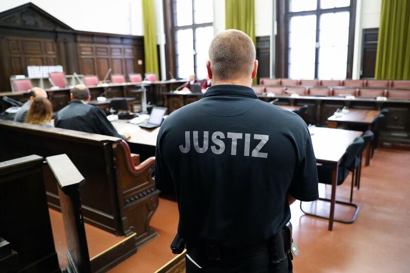 A judicial officer stands in a court room ahead the beginning of the trail against alleged Turkish spy Mehmet S in Hamburg, northern Germany, on September 7, 2017.
The 32-year old is accused of having spied on Kurds in Germany for the Turkish National intelligence Organization MIT. / AFP PHOTO / POOL / Christian Charisius