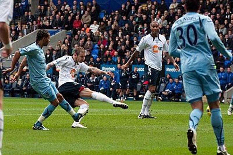 Gretar Steinsson, centre, strikes the ball past Heurelho Gomes in the Tottenham goal to put Bolton Wanderers two goals up.