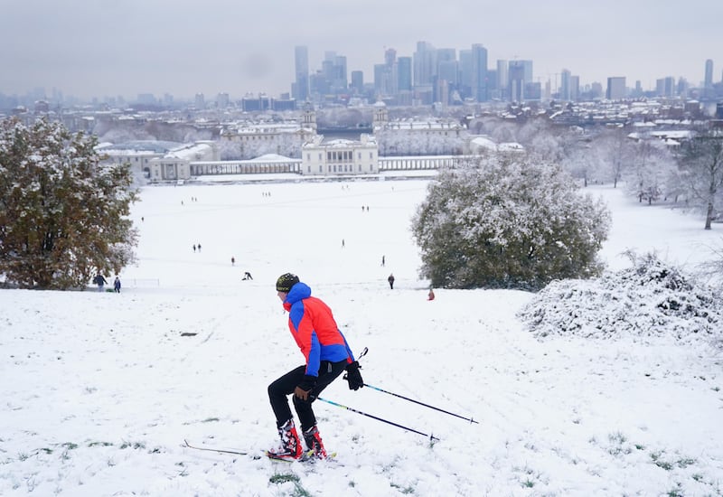 A person skis in the snow at Greenwich Park, south-east London. PA
