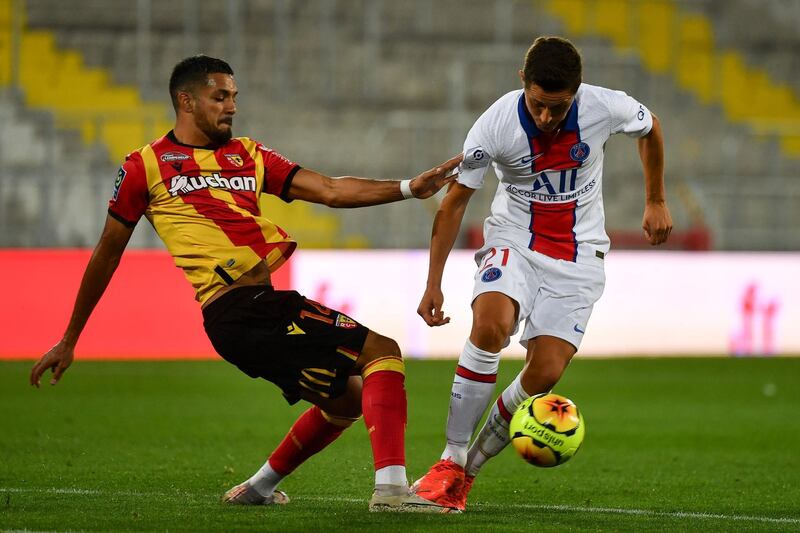 Lens' defender Facundo Medina, left, fights for the ball with Paris Saint-Germain's midfielder Ander Herrera. AFP