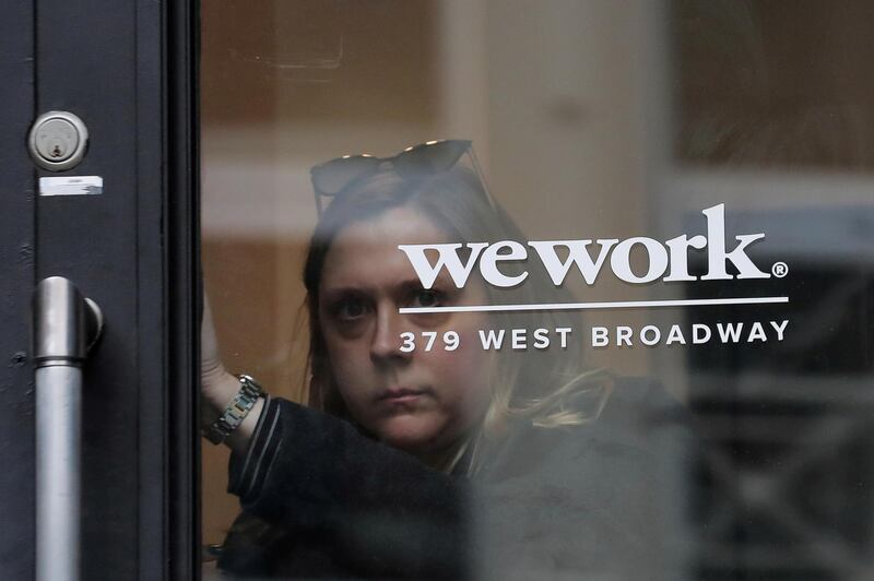 FILE PHOTO: A woman exits a WeWork co-working space in New York City, New York U.S., January 8, 2019. REUTERS/Brendan McDermid/File Photo