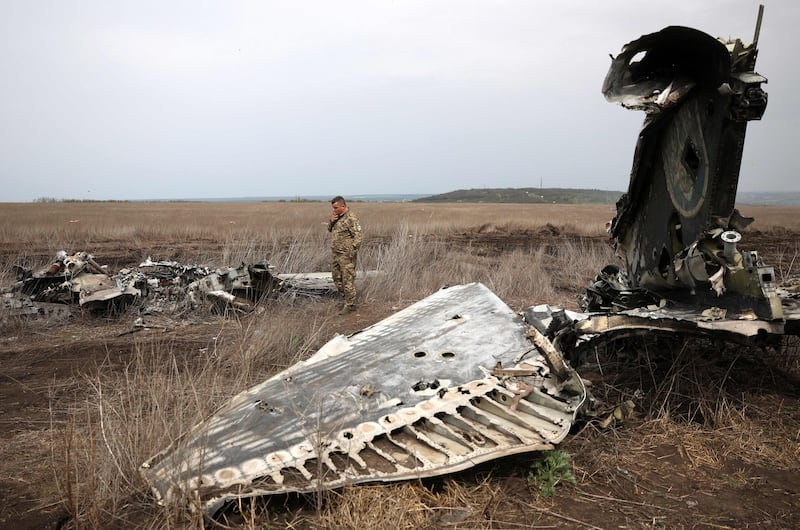 Ukrainian Lt Col Serhiy Verbytsky examines the remains of his SU-24M aircraft on the outskirts of Izyum, Kharkiv. AFP