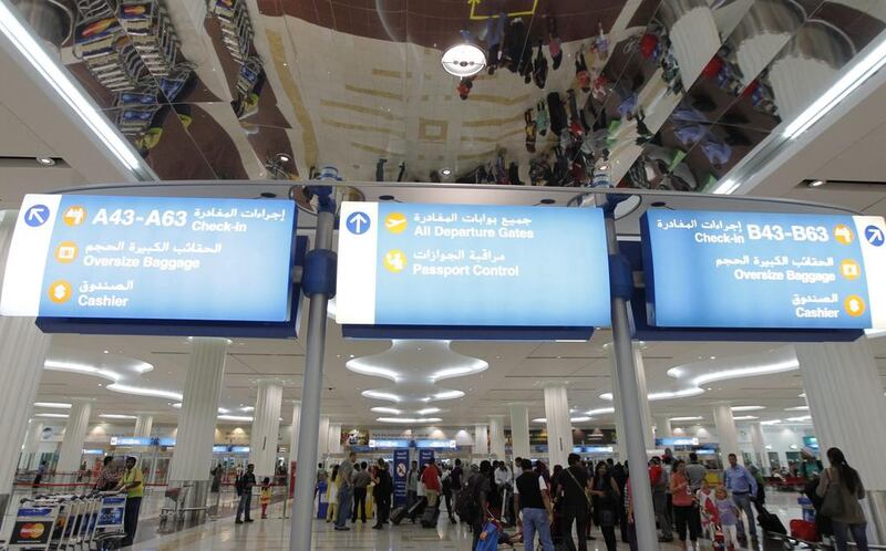 Travellers pass through the Emirates terminal at Dubai International Airport. Jumana El Heloueh / Reuters