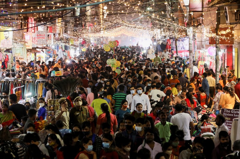 People shop at a crowded market in New Delhi. Reuters