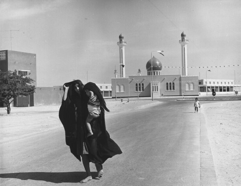 New residents of the recently built town of Isa Town, with one of the two new mosques, in November 1968.