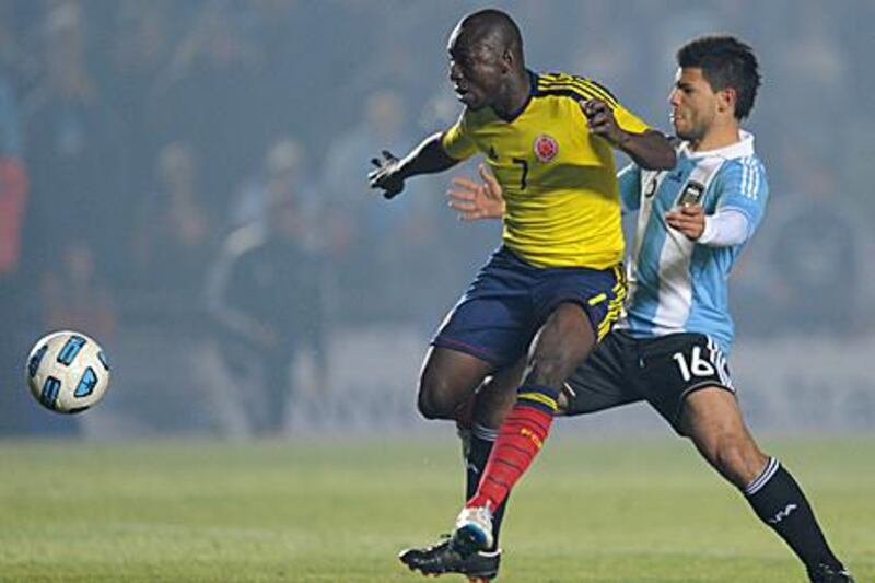 Pablo Armero, the Colombia defender, shields the ball safely from the Argentina forward Sergio Aguero. The two teams drew 0-0 in another disappointing match for hosts Argentina.