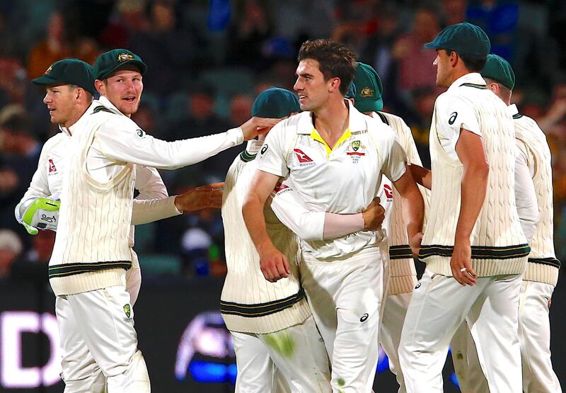 Australia's Pat Cummins celebrates with teammates after bowling England's Dawid Malan. David Gray / Reuters