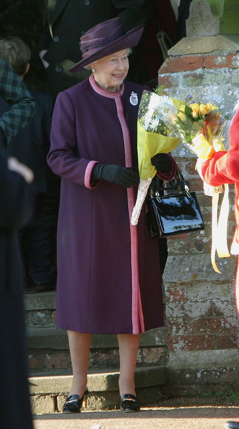 Queen Elizabeth II, wearing purple, leaves Sandringham Church after attending the Christmas Day service on December 25, 2004, in Norfolk, England. Getty Images