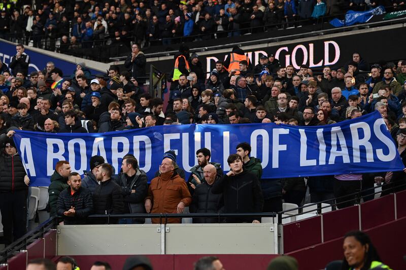 Everton fans with banners protesting against the club's owners. AFP