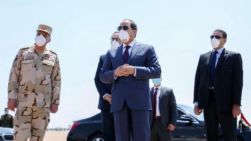 (FILES) This file handout picture released by the Egyptian Presidency on April 7, 2020, shows Egyptian President Abdel Fattah al-Sisi (C) wearing a facemask as a protective measure against the novel coronavirus, during a visit to the Huckstep military base east of the capital Cairo. A slickly produced video from Egyptian president Abdel Fattah al-Sisi's office, complemented by a dramatic score, showed in April crates of medical supplies in wrapping that read in English and Arabic, "from the Egyptian people to the American people," being loaded onto a military cargo plane. It was Egypt's latest expression of its soft power globally by sending medical aid to various countries that have included China, Italy, Sudan and the United Kingdom, but analysts say this gesture of political goodwill is insufficient in dealing with the pandemic. - === RESTRICTED TO EDITORIAL USE - MANDATORY CREDIT "AFP PHOTO / HO / EGYPTIAN PRESIDENCY' - NO MARKETING NO ADVERTISING CAMPAIGNS - DISTRIBUTED AS A SERVICE TO CLIENTS ==
 / AFP / EGYPTIAN PRESIDENCY / - / === RESTRICTED TO EDITORIAL USE - MANDATORY CREDIT "AFP PHOTO / HO / EGYPTIAN PRESIDENCY' - NO MARKETING NO ADVERTISING CAMPAIGNS - DISTRIBUTED AS A SERVICE TO CLIENTS ==
