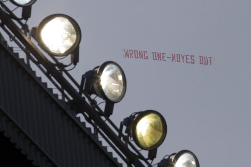 A banner critical of manager David Moyes is flown above Old Trafford Stadium during Manchester United’s English Premier League soccer match against Aston Villa, in Manchester, England on Saturday March 29, 2014. AP Photo/Jon Super
