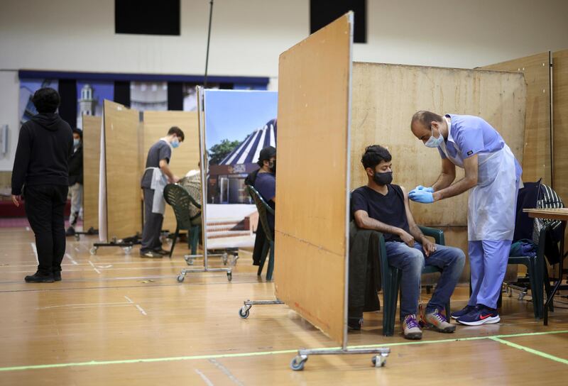 A man receives an injection with a dose of AstraZeneca coronavirus vaccine, at a vaccination centre in Baitul Futuh Mosque, amid the outbreak of coronavirus disease (COVID-19), in London, Britain, March 28, 2021. REUTERS/Henry Nicholls