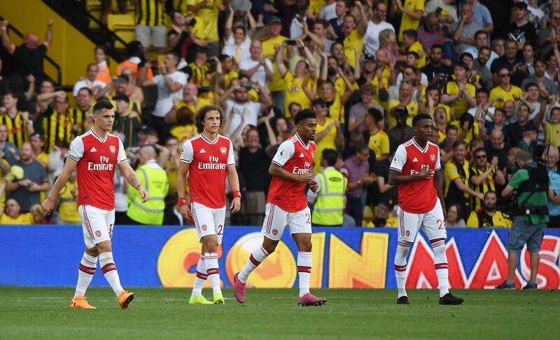 Arsenal players look dejected after letting a two goal lead slip away against Watford. EPA