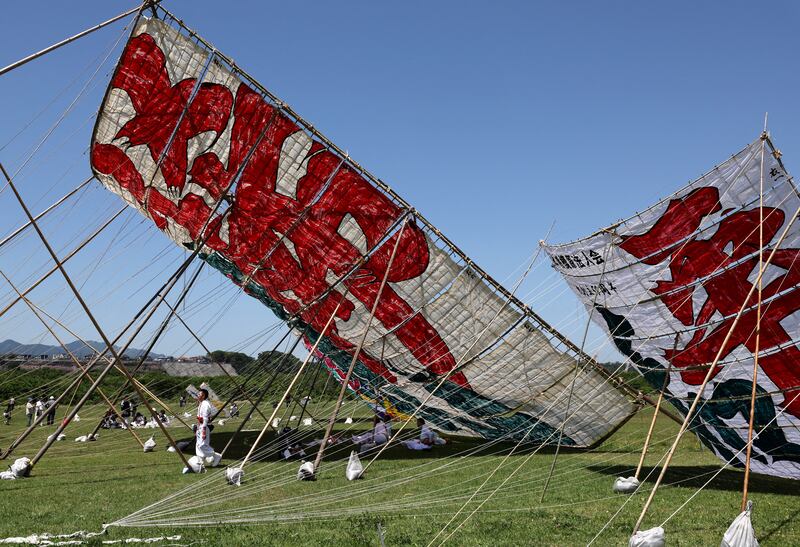 Kite fliers wait to fly Japan's largest kite, measuring 14.5 by 14.5 metres and weighing 950kg, at the Oodako Matsuri festival, in Sagamihara, south of Tokyo. Reuters