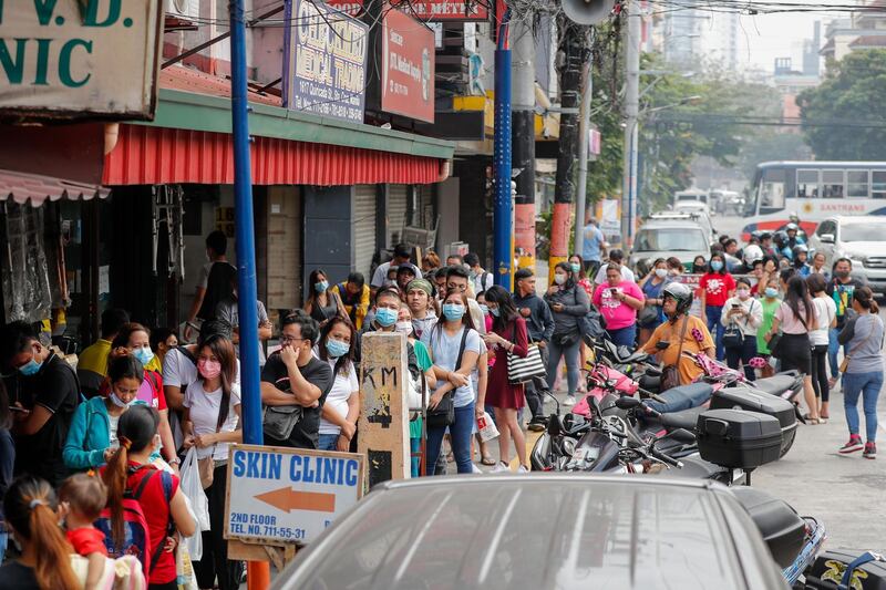 People queue to purchase face masks at a medical supply store in Manila, Philippines.  EPA