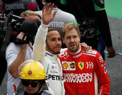 Mercedes driver Lewis Hamilton, of Britain, and Ferrari driver Sebastian Vettel, of Germany, right, embrace at the end of the Formula One Mexico Grand Prix auto race at the Hermanos Rodriguez racetrack in Mexico City, Sunday, Oct. 28, 2018. (AP Photo/Marco Ugarte)