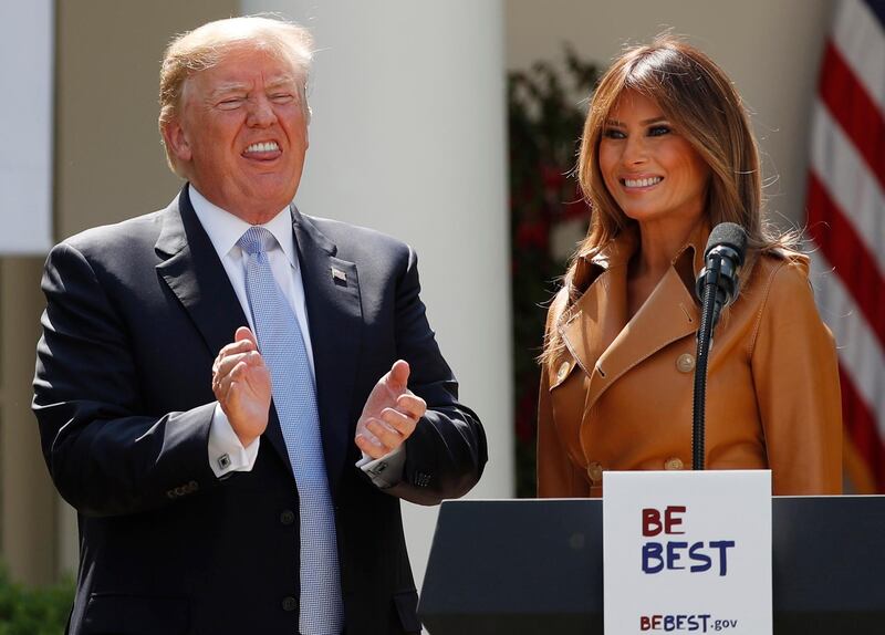 U.S. first lady Melania Trump stands with President Donald Trump, who applauds during the launch of the first lady's Be Best initiatives in the Rose Garden of the White House in Washington, U.S., May 7, 2018. REUTERS/Kevin Lamarque