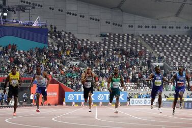 Christian Coleman, third right, wins the men's 100m gold medal at the World Athletics Championships, although there were many empty seats inside the stadium. AP Photo