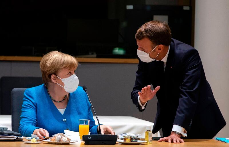 Germany's Chancellor Angela Merkel (L) talks with France's President Emmanuel Macron prior the start of the EU summit at the European Council building in Brussels, on July 18, 2020, as the leaders of the European Union hold their first face-to-face summit over a post-virus economic rescue plan. The EU has been plunged into a historic economic crunch by the coronavirus crisis, and EU officials have drawn up plans for a huge stimulus package to lead their countries out of lockdown.
 / AFP / POOL / Francisco Seco
