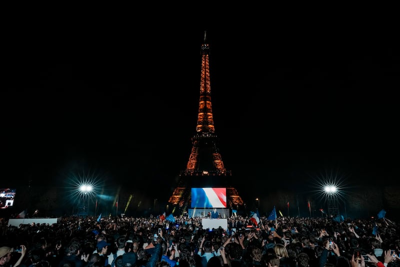 Supporters celebrate with Mr Macron in front of the Eiffel Tower. AP Photo