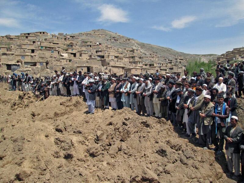 Afghan villagers offer funeral prayers for the victims buried amid debris of their collapsed houses in Argu village, Badakhshan province, Afghanistan on May 3. Nasir Waqif / EPA