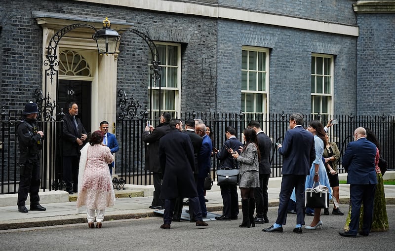 Members of the Muslim community queue to have their pictures taken in front of 10 Downing Street in London, as they arrive for an Eid reception on April 15. PA