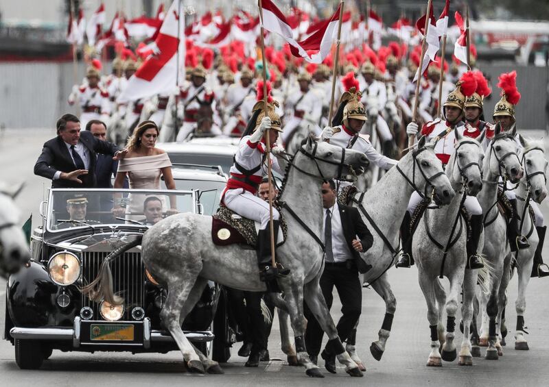 Jair Bolsonaro and wife Michele head to the Planalto Palace on a Rolls Royce. EPA