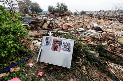 Family photos on the remains of a refrigerator at the site of the demolished house in Sheikh Jarrah. Reuters