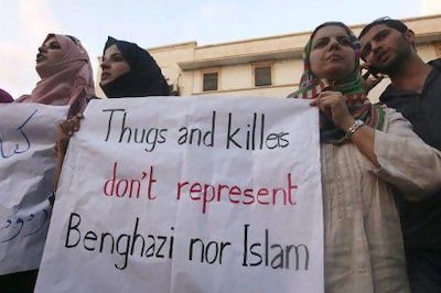 Demonstrators in Benghazi hold a message during a rally to condemn the killers of the US ambassador to Libya,  Christopher Stevens, and the attack on the US consulate. Reuters