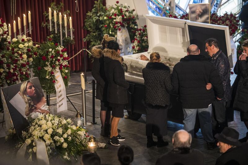 OFFENBACH, GERMANY - FEBRUARY 24: Mourners gather prior to the funeral of the victim Mercedes K. (35) of last week's mass shooting at the coffin with Mercedes K. (35) in the funeral hall on February 24, 2020 in Offenbach am Main, Germany. Tobias Rathjen shot dead nine men and women, all of immigrant heritage, at two hookah bars in Hanau on February 20 before killing his mother and himself. Police are certain of a right-wing motive to the crime and suspect Rathjen, who promoted conspiracy theories on YouTube, acted on his own. (Photo by Thomas Lohnes/Getty Images)
