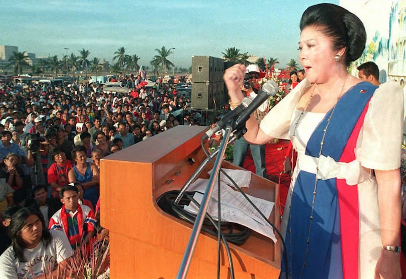 Imelda Marcos speaks to her followers in Manila during their own celebration to mark the 10th anniversary of the downfall of her husband, the late dictator Ferdinand Marcos, in 1996. AFP