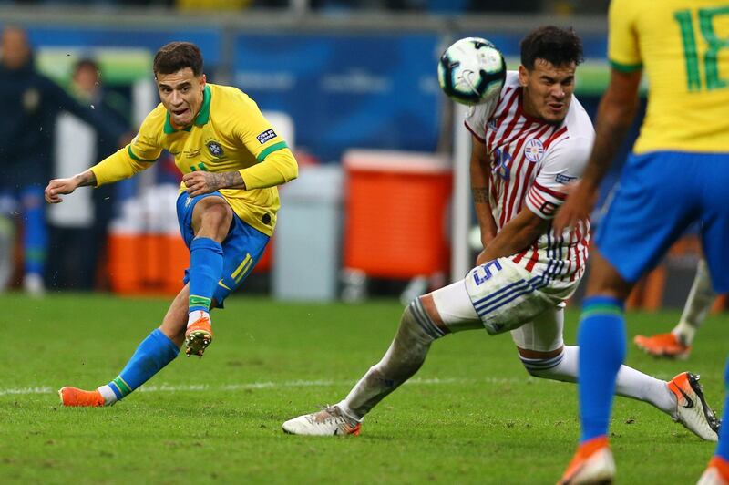 Philippe Coutinho of Brazil kicks the ball against Gomez of Paraguay. Getty Images