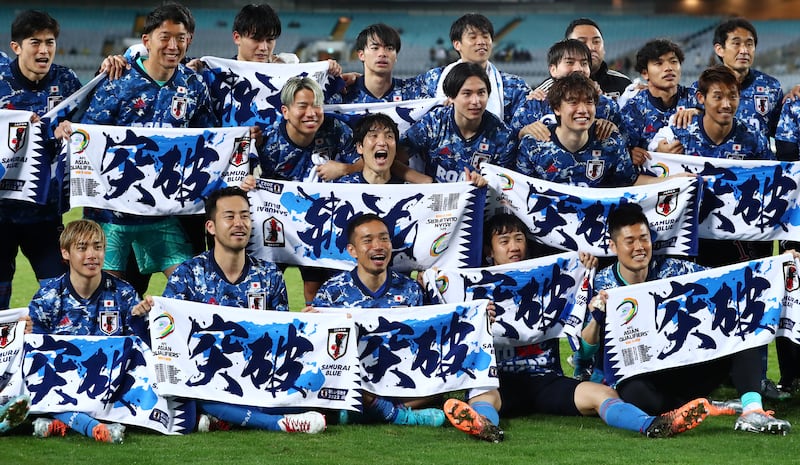Japan celebrate after qualifying for the Qatar World Cup. Getty