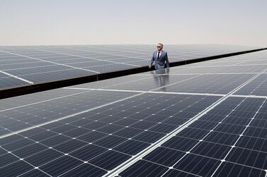 Jorge Perea, executive managing director walks alongside some of the three million-plus solar panels at the Noor plant in Abu Dhabi. Pawan Singh / The National 