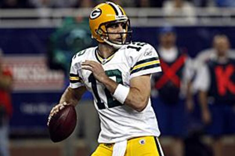 Green Bay Packers quarterback Aaron Rodgers looks for a receiver during the first half of the Thanksgiving Day game against the Detroit Lions.