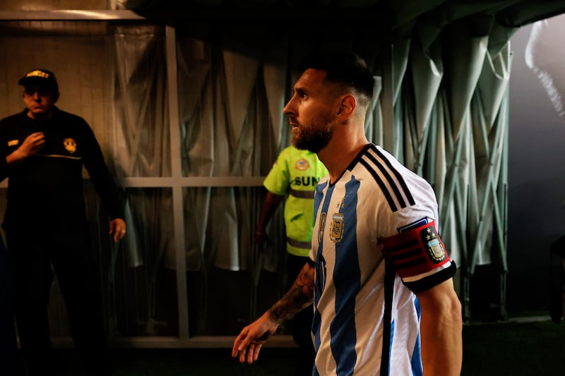 Lionel Messi walks through the tunnel to return to the dressing room after crowd trouble delays the start of the match. Getty Images