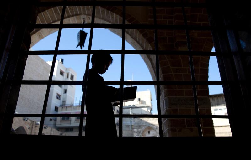 A Palestinian boy reads verses of the Quran at Al Omari mosque in Gaza City. AP Photo