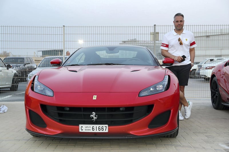 DUBAI, UNITED ARAB EMIRATES, August 31 – 2018 :- Sebastian Roesner with his Ferrari car at the Dubai Autodrome in Dubai. Members and Guests of the Ninth Degree supercars club driving their cars during the Ninth Degree supercars club meet held at Dubai Autodrome in Dubai. ( Pawan Singh / The National )  For Motoring. Story by Adam Workman