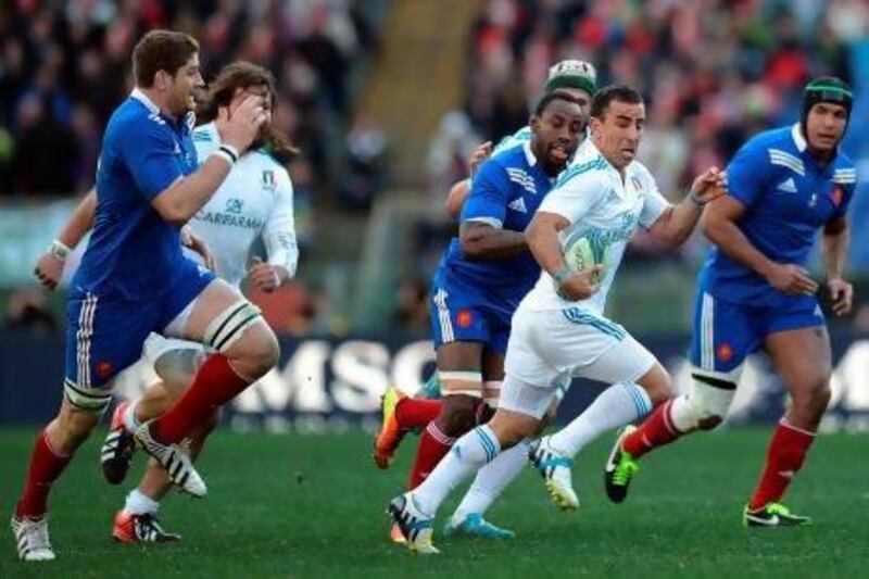 Italy fly-half Luciano Orquera, centre, with the ball, earned Man of the Match honours for the Azzurri in their upset of France.