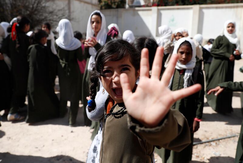 A girl reacts as she waits to get a school bag provided by a local aid group, Mona Relief Yemen, at a public school in Sana'a, Yemen. Mona Relief Yemen has distributed school bags to encourage girls to keep attending classes as the number of out-of-school children is estimated more than two million, compared to 1.6 million before the ongoing war escalated in Yemen in 2015.  EPA