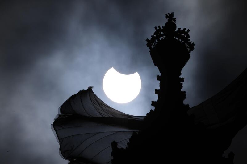 A partial solar eclipse is seen over the Houses of Parliament in London, England. Getty Images